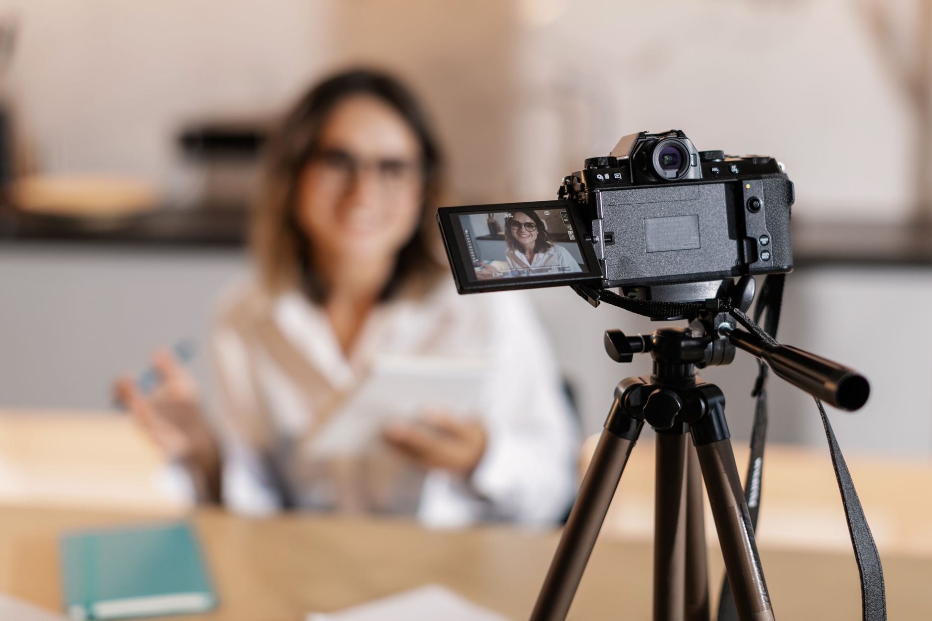 Creator filming with a camera and tripod for video content