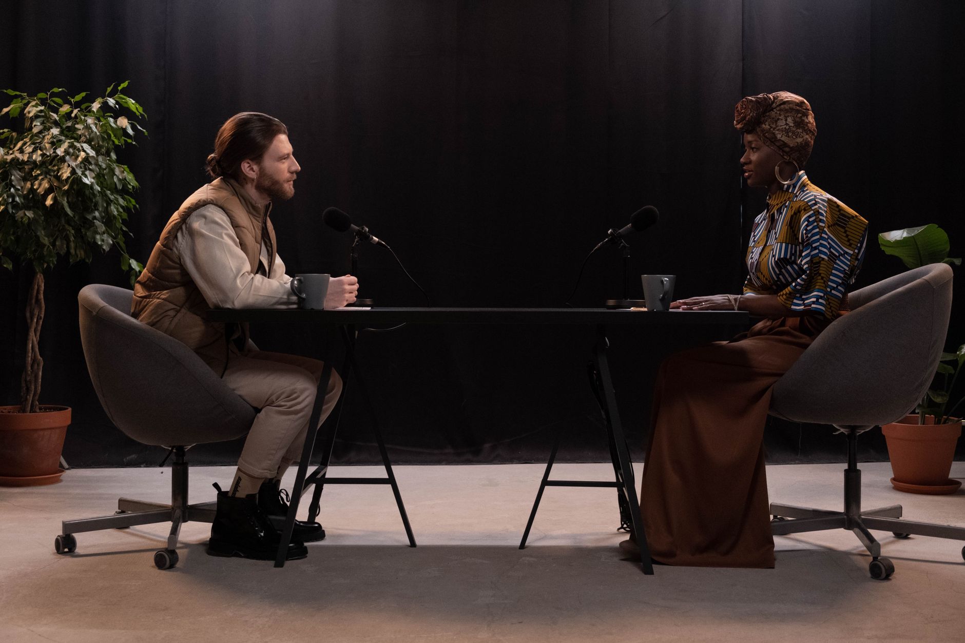 Two people recording a podcast conversation with microphones