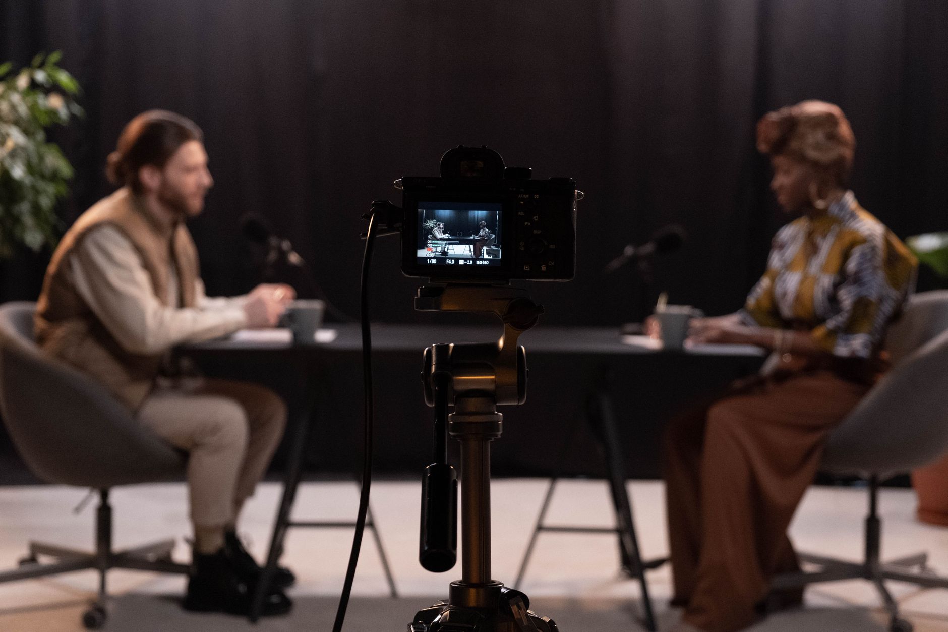 Two creators recording in a simple home studio setup