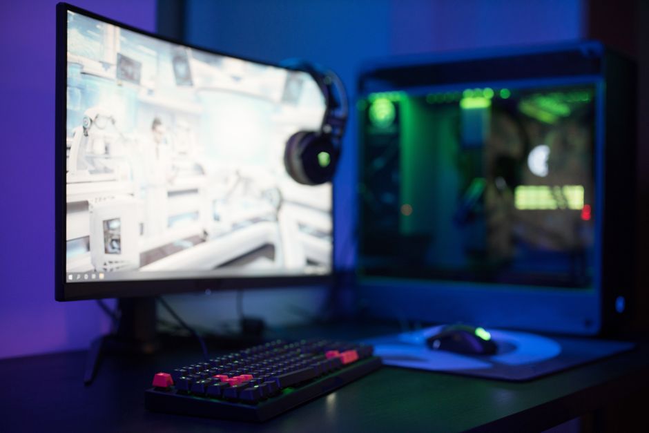 A gaming setup with an RGB backlit keyboard