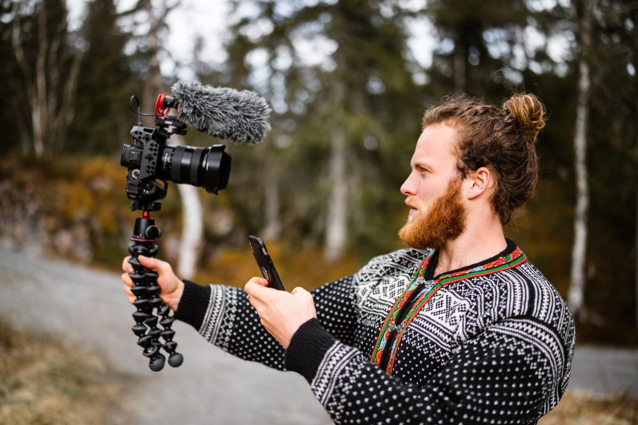 Vlogger filming outdoors with a handheld vlogging camera