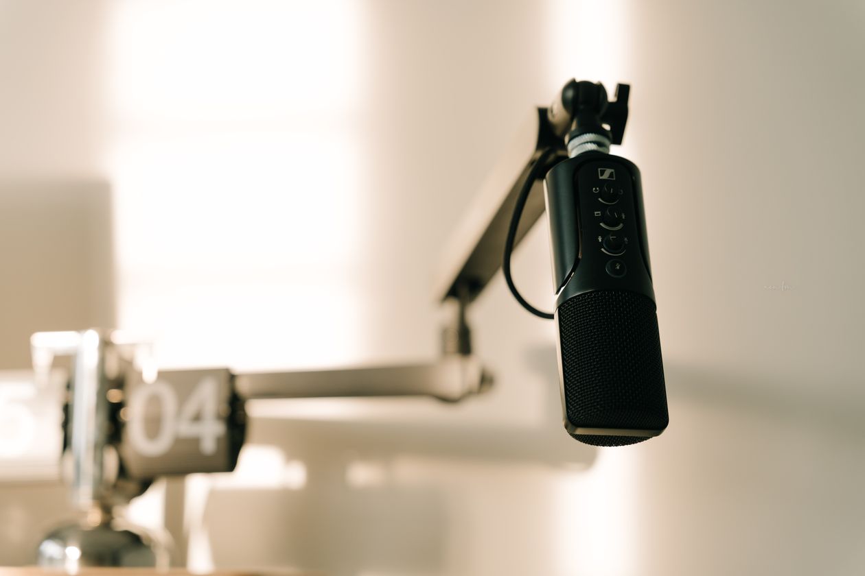 Professional podcast microphone on a boom arm in a studio
